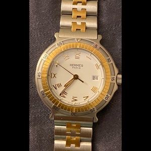 Authentic Hermes Captain Nemo watch gold stainless steel quartz analog display.